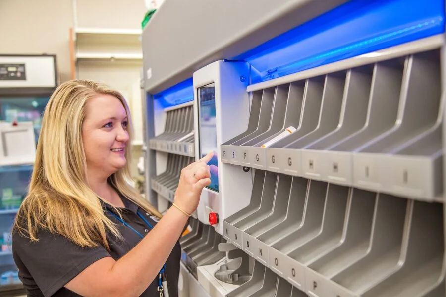 Pharmacy team member using an automated medication dispensing machine
